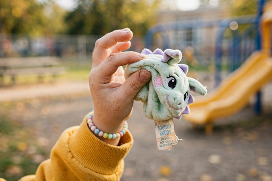 A kid holding up a slightly off knockoff squishy toy on a playground — the kind of thing Gen Alpha would call "so AI".